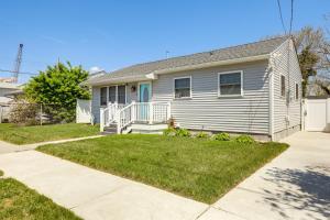 a white house with a porch and a yard at Atlantic City Home with Gas Grill Near 8 Beaches! in Atlantic City