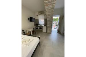 a living room with a bed and a kitchen at Politimis Studio N6 in Amorgos