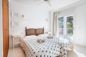 a bedroom with a bed with two teddy bears on it at Villa Mar - Can Bujosa in Palma de Mallorca +19 photos