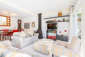 een woonkamer met twee witte banken en een tafel bij Villa Mar - Can Bujosa in Palma de Mallorca