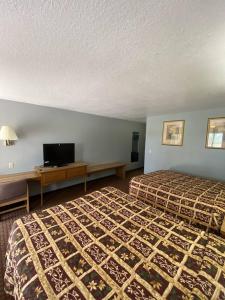 Ένα ή περισσότερα κρεβάτια σε δωμάτιο στο Land of Ahs Motor Inn