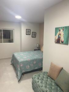a bedroom with a bed and a horse painting on the wall at Elegante y lindo departamento in Santa Cruz de la Sierra