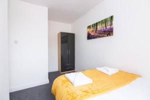 ein Schlafzimmer mit einem Bett und einem Wandgemälde in der Unterkunft 4 bedroom house, 5 double beds in Leeds