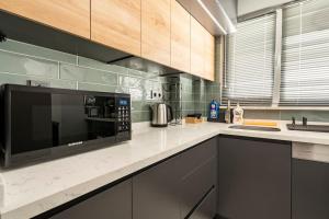 a kitchen with a microwave on a counter at Tomtom HOUSE Centre Location in Istanbul