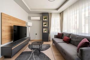 a living room with a couch and a flat screen tv at Tomtom HOUSE Centre Location in Istanbul