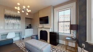 a living room with a couch and a tv at 1-31 Excellent Location, Walk Everywhere Sleeps 3 in Boston