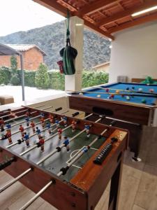 a room with a table with a pool at Casa Cal Gansoleta in La Coma i la Pedra