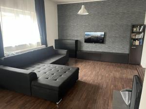a living room with a couch and a tv at Celý dům + zahrada in Pardubice