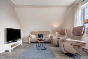 uma sala de estar com um sofá e uma televisão em Ferienwohnung Harzreich em Seesen