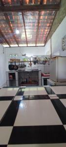 a kitchen with a checkered floor in a kitchen at Eco Hostel Lunar in Soure