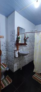 a bathroom with a sink and a toilet at Eco Hostel Lunar in Soure