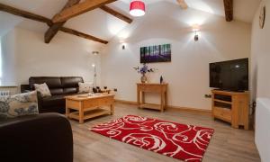 a living room with a couch and a red rug at Abbots Reading Mews 1 in Lake Side