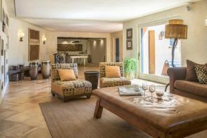 a living room with a couch and a table at Villaflair - Sea View Porto Ercole in Porto Ercole