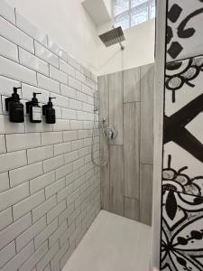 a bathroom with a shower with white subway tiles at Vacanze Romane in Lido di Ostia