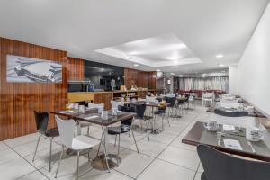 ein Restaurant mit Tischen und Stühlen in einem Zimmer in der Unterkunft Exe Convention Plaza Madrid in Madrid