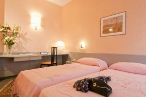 Postel nebo postele na pokoji v ubytování Hotel Garda