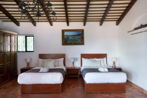 a bedroom with two beds and two lamps in it at 3 Bedroom Spacious Villa with Pool & Lake view in Ajijic