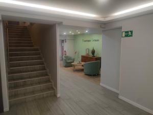 a hallway with a staircase and a living room at Boutique Urban Madrid Serrano in Madrid