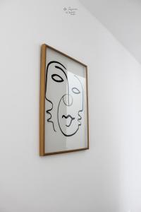 a picture of a face on a wall at Nomad Houses - Ap Tereno in Beja
