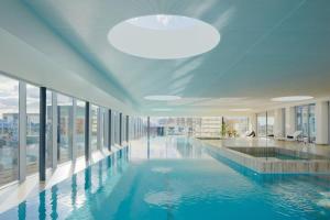 a large swimming pool in a building with windows at Fawkner Apartment Bay-view 4 in Melbourne