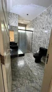 a bathroom with a shower and a toilet and a sink at Casa Olinda in Olinda