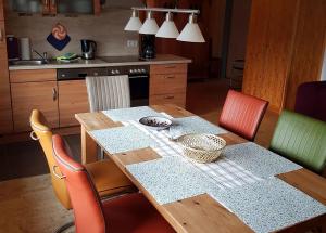 eine Küche mit einem Holztisch mit Stühlen in der Unterkunft Ferienwohnungen Tenge in Hooksiel