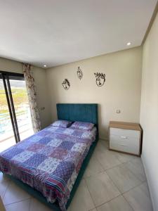 a bedroom with a bed with a quilt on it at Smir Park,Tetouan in Marina Smir