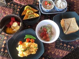 a table topped with plates of food and bowls of food at The Tropical Koh Mook in Koh Mook