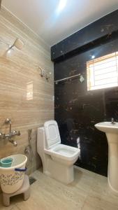 a bathroom with a toilet and a sink at M premium executive apartment in Bangalore