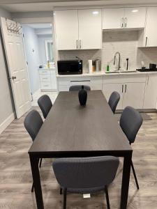a dining room table with chairs and a kitchen at River View House Basement in Kamloops