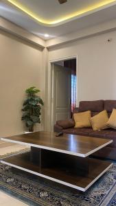 a living room with a couch and a coffee table at M premium executive apartment in Bangalore