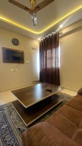 a living room with a couch and a table at M premium executive apartment in Bangalore