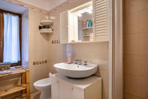 a bathroom with a sink and a toilet at La casa di Ketty in Bieno +16 photos
