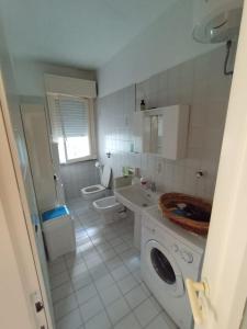 een witte badkamer met 2 toiletten en een wastafel bij Residence Leonardo in Silvi Marina