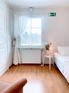 a bedroom with a bed and a window at Expe Finland in Porvoo