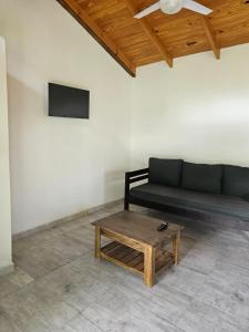 a living room with a couch and a coffee table at Las Casitas del Pozo in Villa General Belgrano