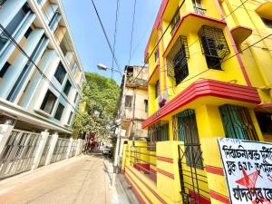 a yellow building on the side of a street at Stylish 1RK Serviced Apartment in Tollygunge in Kolkata