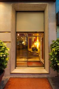 a window of a building with a reflection in it at Hotel Garda in Milan