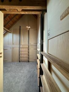 a walk in closet with wooden ceilings and shelves at LES BRIQUES in Lion-sur-Mer