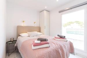 a bedroom with a large bed with towels on it at BRAND NEW PENTHOUSE TERRACE BBQ WIFI MODERN MALAGA in Málaga
