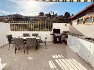 a patio with a table and chairs on a balcony at Amber Holiday Home in Peniscola