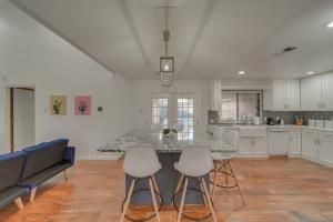 a kitchen with a table and chairs in a room at 5BD-3BA Bright & Cheerful Backyard Pool Retreat in Richardson