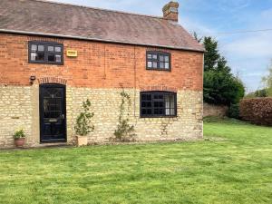 a brick building with a black door and a yard at 3 Bed in Bicester 94701 