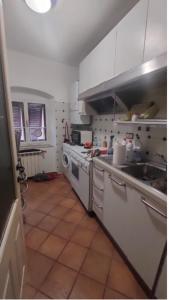 a kitchen with a sink and a washing machine at Il Nido di Paola in Carrara