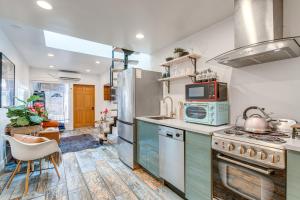 a kitchen with a stove and a microwave at Denver Tiny House Walk to Cafes, Bars, Eateries! in Denver