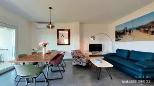 ein Wohnzimmer mit einer blauen Couch und einem Tisch in der Unterkunft Apartment Perlita in Fažana