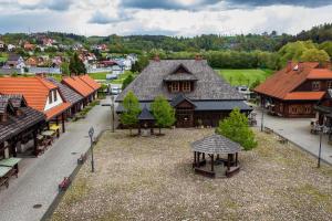 an aerial view of a town with wooden buildings at NOVA.Galicja in Nowy Sącz