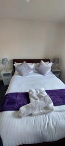 a white bed with two pairs of socks on it at Guest Village in Hull