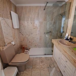 a bathroom with a shower and a toilet and a sink at LAS MIMOSAS PARADISE in La Cala de Mijas +7 photos