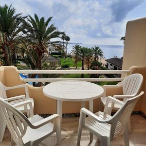 a balcony with a table and chairs and the ocean at LAS MIMOSAS PARADISE in La Cala de Mijas